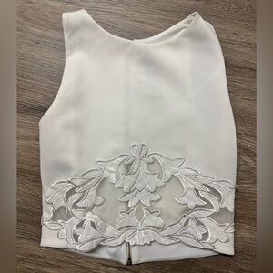 White crop top with floral lace cutout and zipper closure by Design Lab